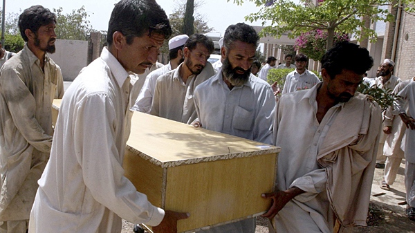 People carry a casket of their relative killed in the suicide bombing in Kohat, Pakistan on Sunday, April 18, 2010. (AP)