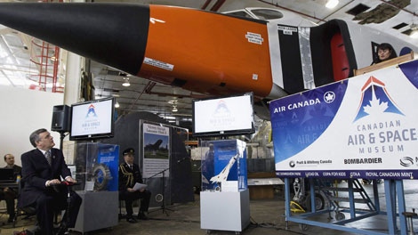 A full-scale replica of the legendary Avro Arrow towers over Ontario Lieutenant Governor David C. Onley at the Canadian Air & Space Museum in Toronto in this Feb. 20, 2009 photo. (THE CANADIAN PRESS/Nathan Denette)
