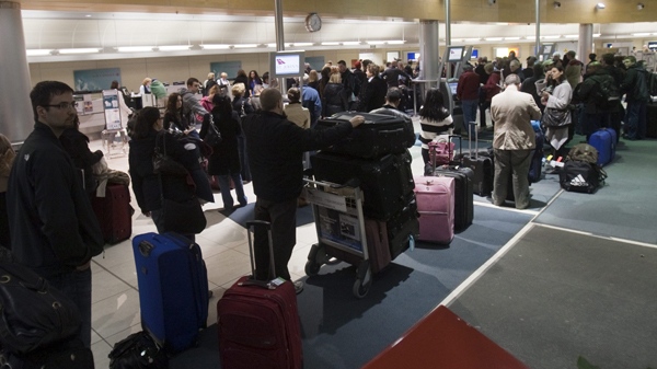Passengers wait to check-in at midnite at St. John's International Airport, Sunday, April 18, 2010. (Ryan Remiorz / THE CANADIAN PRESS) 