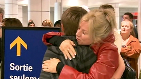 A mother embraces her 12-year-old son after he arrived at Montreal's Trudeau airport, Tuesday, April 20, 2010.