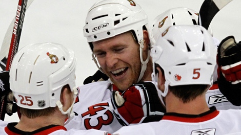 Ottawa Senators' Matt Carkner, center, celebrates his game-winning goal in the third overtime period of a first-round NHL playoff hockey game against the Pittsburgh Penguins, with teammates Chris Neil, left, and Andy Sutton, right, in Pittsburgh on Thursday, April 22, 2010. The Senators won 4-3. (AP Photo/Gene J. Puskar)