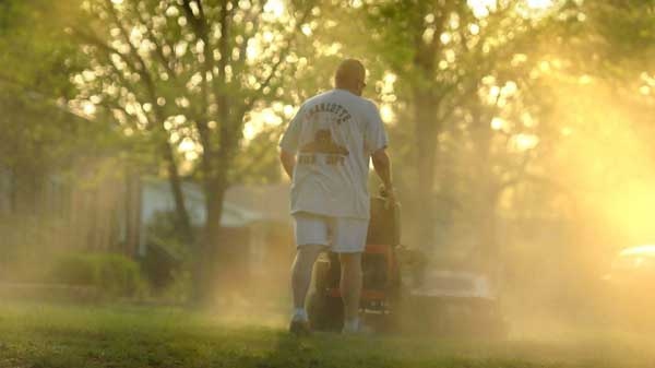 Shane Nantz kicks up a cloud of pollen as he mows the front yard of his west Charlotte, N.C., home on Monday, April 5, 2010. (AP / The Charlotte Observer, Todd Umlin)