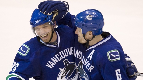 Vancouver Canucks' Mikael Samuelsson, left, celebrates his goal with teammate Sami Salo during the third period against the Los Angeles Kings in game 5 NHL western conference playoff hockey action at GM Place in Vancouver, Friday, April 23, 2010. THE CANADIAN PRESS/Jonathan Hayward