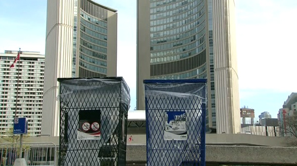 A recycling and garbage bin sit in front of the city hall in downtown Toronto, Monday, April 26, 2010.