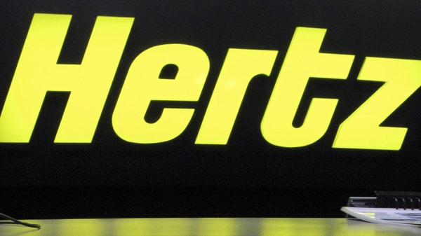 A Hertz logo is seen at the counter at a Hertz car rent in Cedar Rapids, Iowa. (AP / Julie Jacobson)