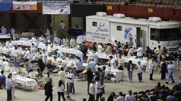 Hundreds of people await free dental services from volunteer dentists and dental technicians at the Remote Area Medical (RAM) clinic inside the Los Angeles Sports Arena in Los Angeles on Tuesday, April 27, 2010. (AP Photo/Damian Dovarganes)