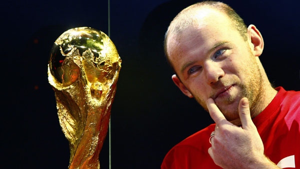 England and Manchester United footballer Wayne Rooney looks at the FIFA World Cup Trophy at Earls Court in London, Thursday, March 11, 2010. The Trophy is making an 86,304 mile global tour taking in 83 countries, in the lead up to the finals of the tournament in South Africa.(AP Photo/Kirsty Wigglesworth)