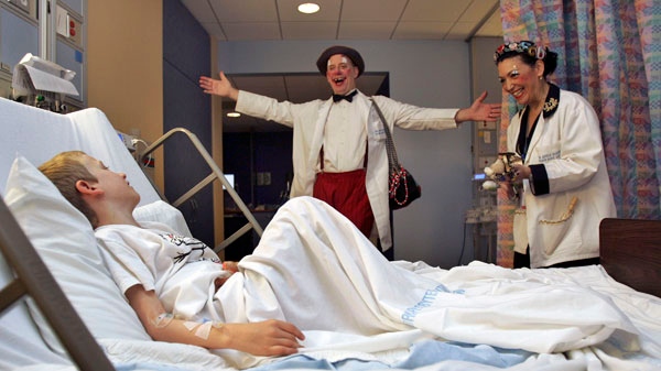 Clowns Stephen Ringold and Phyllis Capello, right, perform for Connor Moran, 7, during their Clown round at New York-Presbyterian's Morgan Stanley Children's Hospital in New York on December 1, 2006. (AP / Dima Gavrysh)