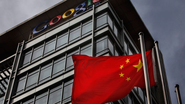 A Chinese flag blows in the air below the Google logo outside the Google China headquarters in Beijing Thursday, March 25, 2010.  (AP /  Gemunu Amarasinghe)