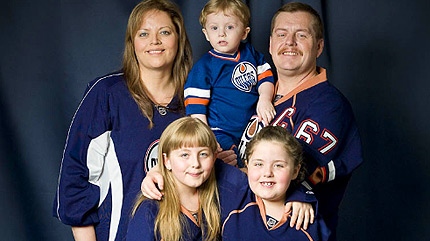 Julianne Baxter, 9 (front left), Coral, 7 (front right), John Baxter (top left), Alana Baxter and John Jr. are shown in an undated photo. EdmontonOilers.com
