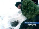 A priest of the Russian Orthodox Church tries to negotiate with members of a doomsday cult through a vent hole of their underground hideout near the village of Nikolskoye, in Penza region about 400 miles (640 kilometers) southeast of Moscow, in this image from the television broadcast Sunday, Nov. 18, 2007. (AP / RTR Russian Channel)