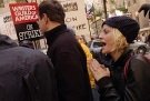 "Saturday Night Live" cast member Amy Poehler, right, is joined by Saturday Night Live writer Steve Higgins, center, outside Rockefeller Center in New York for the first day of a strike by the Writers Guild of America, Monday, Nov. 5, 2007. (AP Photo/Brian McDermott)