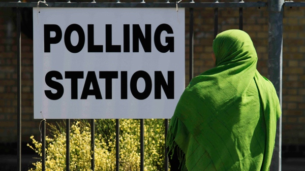 A voter arrives at a polling station in east London, housed in a local school, during Britain's general election on Thursday, May 6, 2010. (AP / Lefteris Pitarakis)
