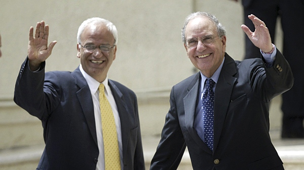 Palestinian chief negotiator Saeb Erakat, left, and U.S. Middle East envoy George Mitchell, right, wave to journalists upon Mitchell's arrival for a meeting with Palestinian president Mahmoud Abbas, not seen, in the West Bank city of Ramallah, Sunday, May 9, 2010. (AP / Majdi Mohammed)