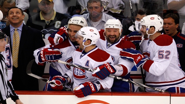 Montreal Canadiens coach Jacques Martin, left, and players, from left, Scott Gomez, Brian Gionta, Glen Metropolit and Mathieu Darche (52) begin to celebrate as time runs out in Game 7 of the NHL hockey Eastern Conference semifinals against the Pittsburgh Penguins in Pittsburgh on Wednesday, May 12, 2010. The Canadiens won 5-2. (AP Photo/Gene J. Puskar)