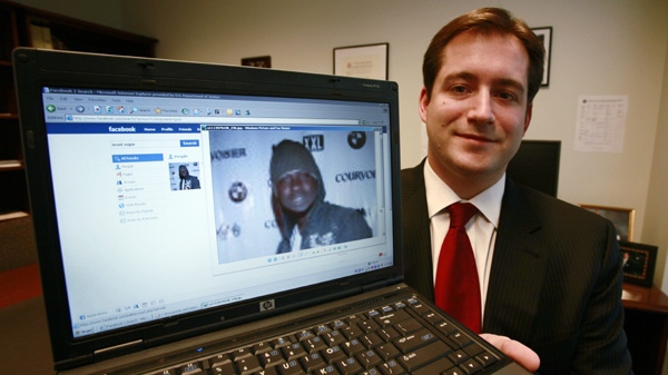 Assistant U.S. Attorney Michael Scoville displays part of the Facebook page, and an enlarged profile photo, of fugitive Maxi Sopo in Seattle, on Oct. 13, 2009. (AP Photo / Elaine Thompson)