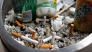 Cigarette butts are seen together with can drinks on a dustin in Beijing, China Friday, May 14, 2010. (AP / Andy Wong)