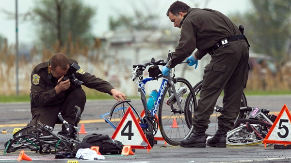 Police examine the scene where a pickup truck plowed into a group of cyclists in Rougemont, Quebec,south of Montreal, Friday, May 14, 2010. (Ryan Remiorz / THE CANADIAN PRESS)