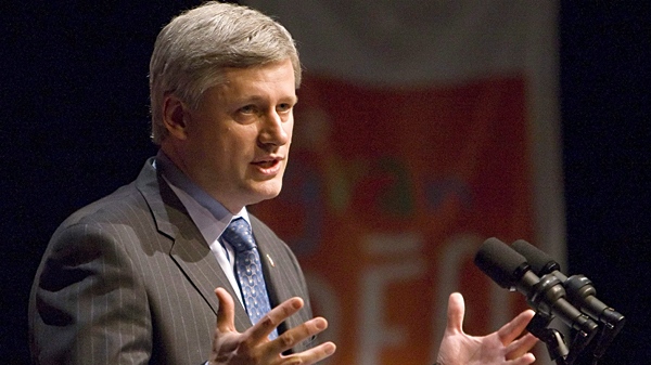 Prime Minister Stephen Harper gestures as he makes an announcement about the foundation of the Grand D�fi, in St-Felicien, Que., Friday, May 14, 2010. (Clement Allard / THE CANADIAN PRESS)