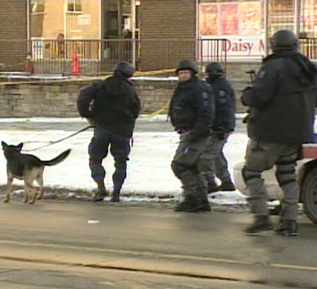 Police officers search the east end neighbourhood for the shooting suspects on Friday, Nov. 23, 2007.