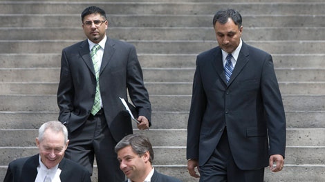 Former ministerial aides Bobbi Virk, left, and Dave Basi are seen leaving the B.C. Supreme Court in downtown Vancouver, Monday, May 17, 2010. THE CANADIAN PRESS/Jonathan Hayward