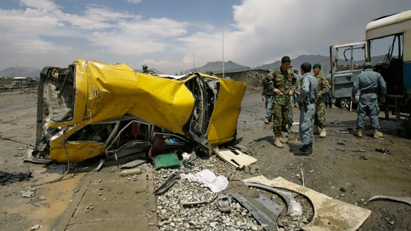 The mangled remains of a vehicle lies at the location of a suicide attack in Kabul, Afghanistan, Tuesday, May 18, 2010. (AP / Ahmad Massoud) 