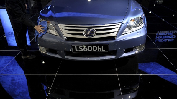 A cleaner wipes a Lexus LS 600hL on display at the booth of Toyota Motor Corp. during the China Auto Show in Beijing, Friday, April 23, 2010. (AP Photo / Andy Wong)