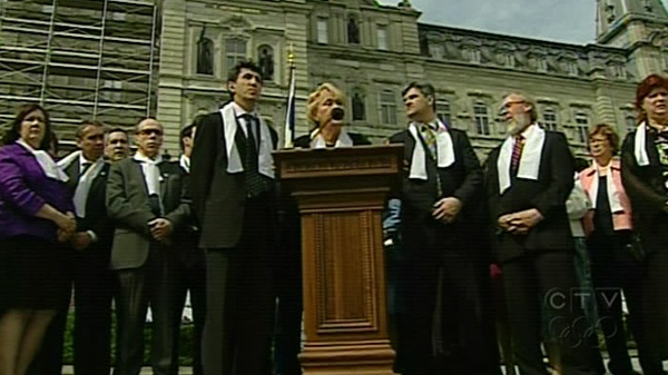 Parti Quebecois leader Pauline Marois (centre), surrounded by members of opposition parties, speaks in front of the National Assembly on Wednesday, May 19, 2010.  