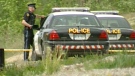 Police officers are seen near the discovery of a body in the area around Barrie, Ont., on Saturday, May 22, 2010.