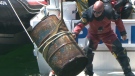 Toronto police work to pull a barrel out of the harbour on Sunday, May 23, 2010. Police say a body was found inside the steel drum, along with concrete and mud.