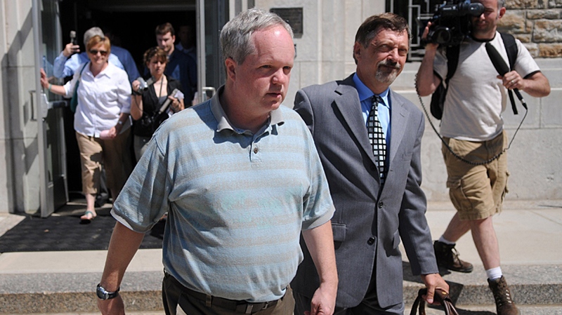 William Melchert-Dinkel, 47, foreground left, leaves the Rice County Courthouse with his lawyer Terry Watkins, second right, after his first court appearance in Faribault, Minn. on Tuesday May 25, 2010. (AP / Star Tribune, Richard Sennott)