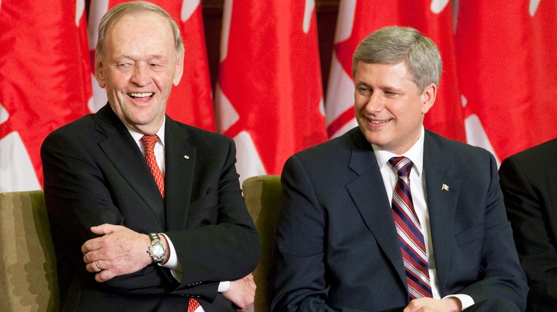 Former Prime Minister Jean Chretien laughs as he is applauded by Prime Minister Stephen Harper during an unveiling ceremony of Chretien's official portrait on Parliament Hill in Ottawa, Tuesday May 25, 2010. (Adrian Wyld / THE CANADIAN PRESS)