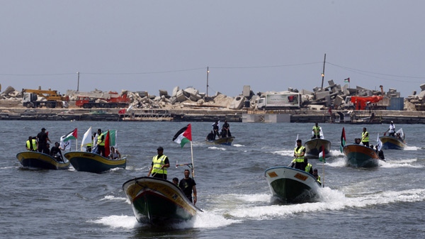Palestinian members of the Hamas naval police ride boats during a display of their preparations for the arrival of the small flotilla carrying donated supplies that organizers say will arrive early next week, at the port in Gaza City, Wednesday, May, 26, 2010. (AP Photo / Khalil Hamra)