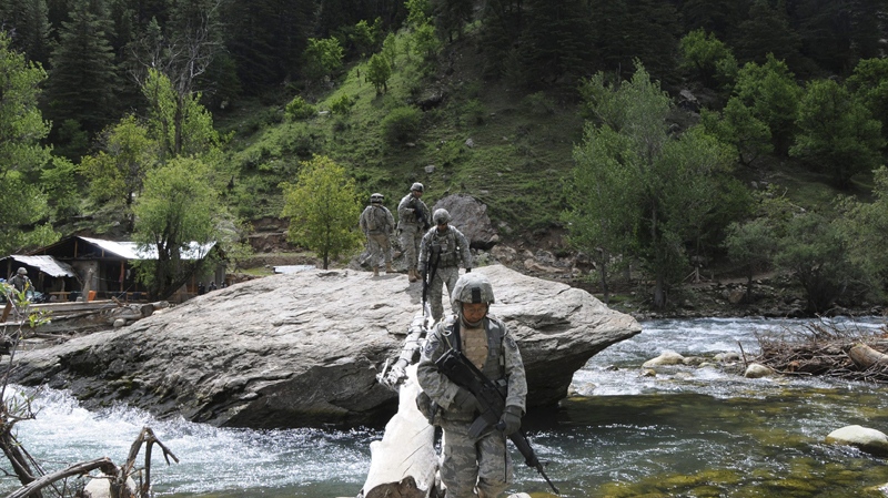U.S. soldiers walk to pass a makeshift bridge on a patrol in Parun, the capital of Nuristan province, east of Kabul, Afghanistan, on Saturday, July 12, 2008. (AP Photo)