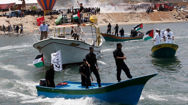 Palestinian members of the Hamas naval police and civilian defense officers ride a boat at Gaza port ahead of the expected arrival of a flotilla of hundreds of pro-Palestinian activists trying to sail into the Gaza Strip, in Gaza city, Saturday, May 29, 2010. (AP / Hatem Moussa)