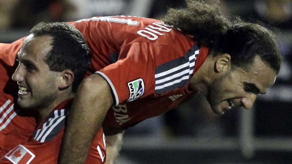 Toronto FC's Dwayne De Rosario, top is lifted by teammate Nick LaBrocca after De Rosario's second goal of the game against the San Jose Earthquakes during the second half of a MLS soccer game in Santa Clara, Saturday, May 29, 2010. Toronto won 3-1.(AP Photo/Marcio Jose Sanchez)