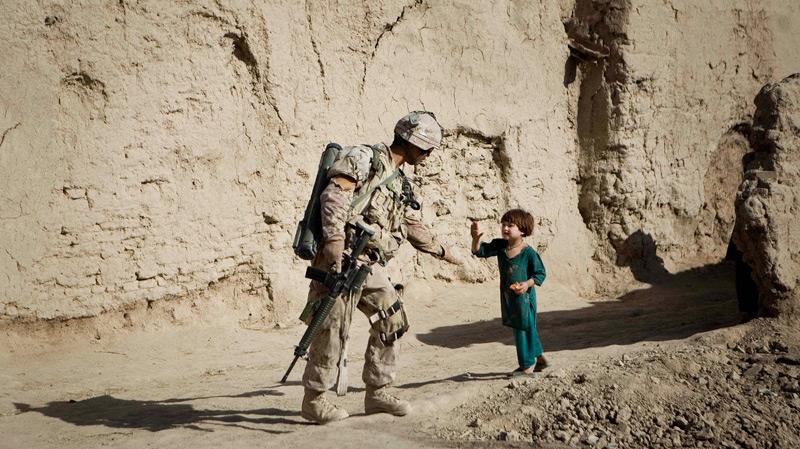 An Afghan girl greets a Canadian soldier with the 1st Battalion, The Royal Canadian Regiment, patroling Salavat, Panjwai district, southwest of Kandahar, Afghanistan, Monday, May 31, 2010. (AP / Anja Niedringhaus)