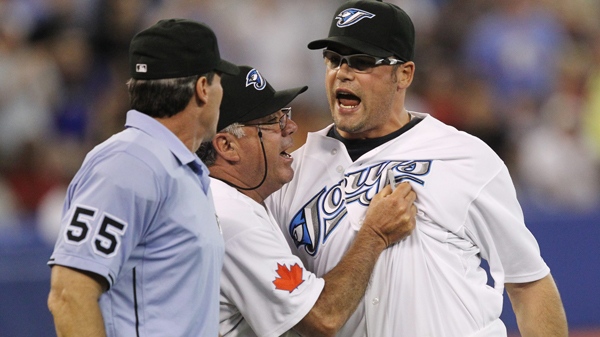 Toronto Blue Jays closer Kevin Gregg is restrained by bench coach Nick Leyva as Gregg yells at home plate umpire Angel Hernandez during ninth inning AL baseball action against the Tampa Rays in Toronto Tuesday, June 1, 2010. (Darren Calabrese / THE CANADIAN PRESS) 