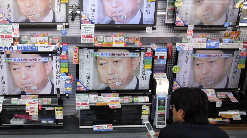 A man watches a news broadcast about Japanese Prime Minister Yukio Hatoyama's decision to step down, at Yamada Denki LABI electric shop at Tokyo's Shimbashi district Wednesday, June 2, 2010. (AP / Itsuo Inouye)