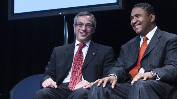 Federal Industry Minister Tony Clement, left, and Kevin Williams, president and managing director of General Motors Canada Limited, centre, share a laugh at an announcement in St. Catharines, Ont., on Tuesday, June 1, 2010. (Nathan Denette / THE CANADIAN PRESS)