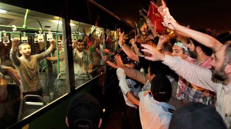Demonstrators chant slogans as they welcome Turkish activists expelled from Israel, at the airport in Istanbul, Turkey, early Thursday, June 3, 2010. (AP / Vadim Ghirda)