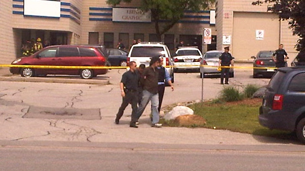 A person is taken into custody by Peel police following the incident in Mississauga, Friday, June 4, 2010. (CTV News)  