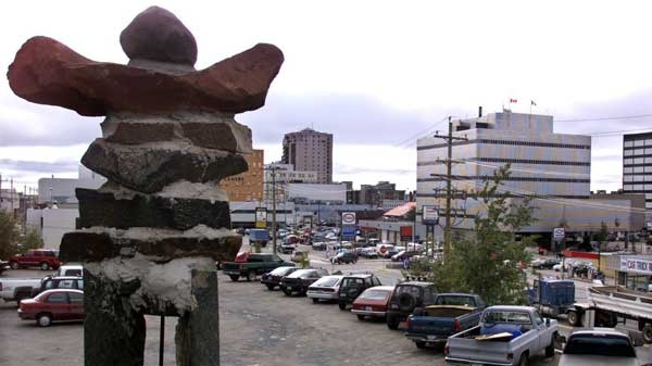 An Inukshuk stands over the skyline of Yellowknife, Tuesday Aug. 21, 2001. (Chuck Stoody / The Canadian Press)