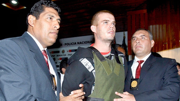 Police officers escort Joran Van der Sloot, second right, during a press conference at a police station in Lima, Saturday, June 5, 2010. (AP / Karel Navarro)