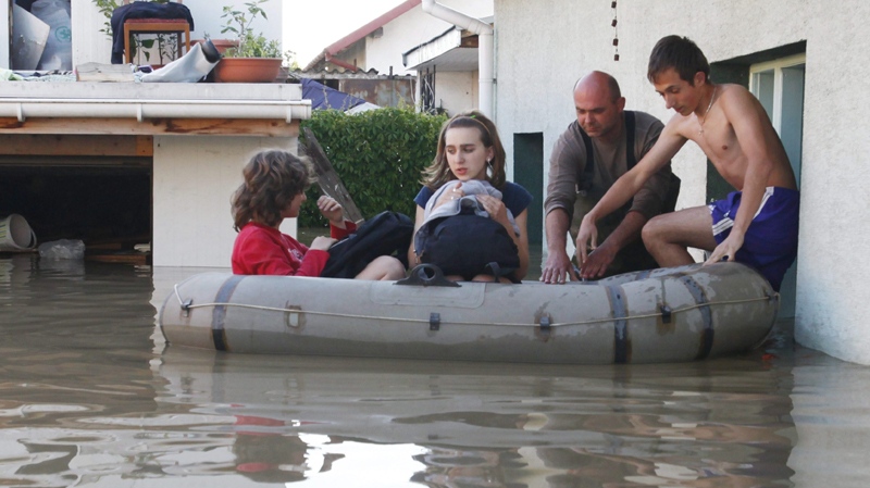 Hieronim Haracz, 2nd right, evacuates his family from their flooded house in Mielec, southern Poland, where the Wisloka River has reached unusually high levels on Saturday, June 5, 2010.(AP Photo/Krzysztof Lokaj)