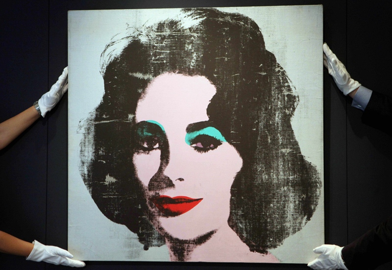 Christie's staff display 'Silver Liz, 1963', a rare portrait of British born actress Elizabeth Taylor by US artist Andy Warhol which has been unseen in public for over 20 years. (AP Photo/Katie Collins, PA)