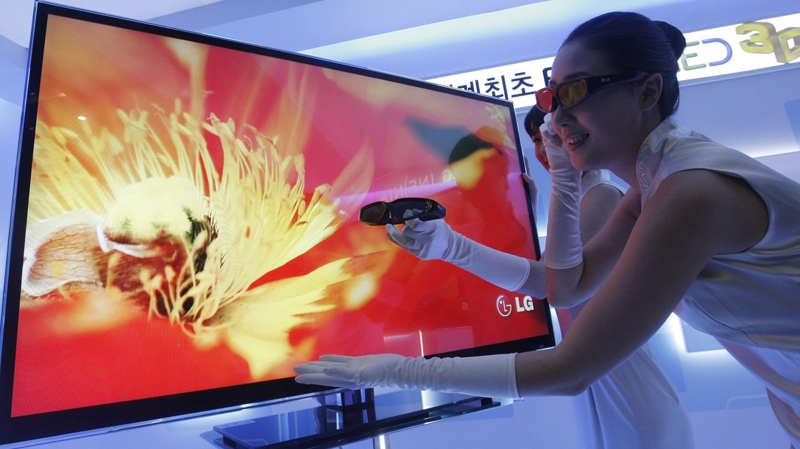 A model wears special glasses to view the world's first Full LED 3D TV  by LG Electronics, the LX9500, during a press unveiling in Seoul, South Korea, Thursday, March 25, 2010.. (AP / Ahn Young-joon)