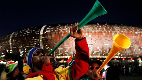 Fans blow vuvuzelas following the World Cup group A soccer match between South Africa and Mexico at Soccer City in Johannesburg, South Africa, Friday, June 11, 2010. The game ended in a 1-1 draw. (AP Photo/Hassan Ammar)