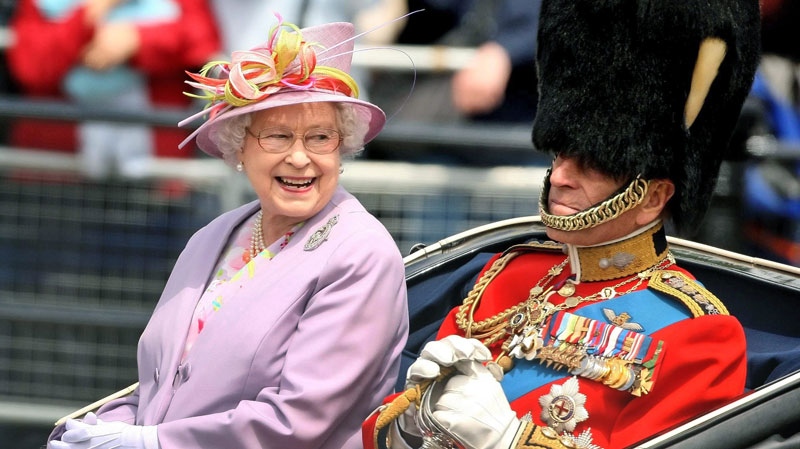 Britain's Queen Elizabeth II and the Duke of Edinburgh return to Buckingham Palace, central London, by carriage following the Trooping the Colour ceremony at Horse Guards Parade Saturday, June 12, 2010. (AP / Dominic Lipinski / PA Wire)