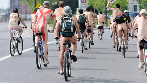 Naked activists ride on a street in Montreal, on Saturday, June 13, 2009, taking part in the World Naked Bike Ride to promote cycling as a clean healthy alternative to cars. (THE CANADIAN PRESS/Graham Hughes)